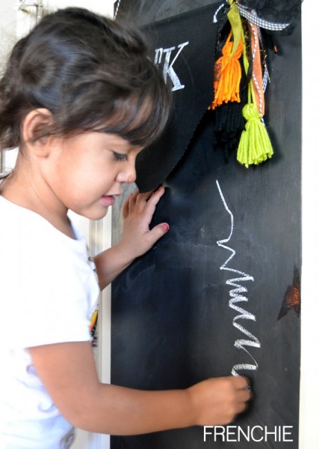 Use a chalkboard door to create and art center for kids on seelindsay.com