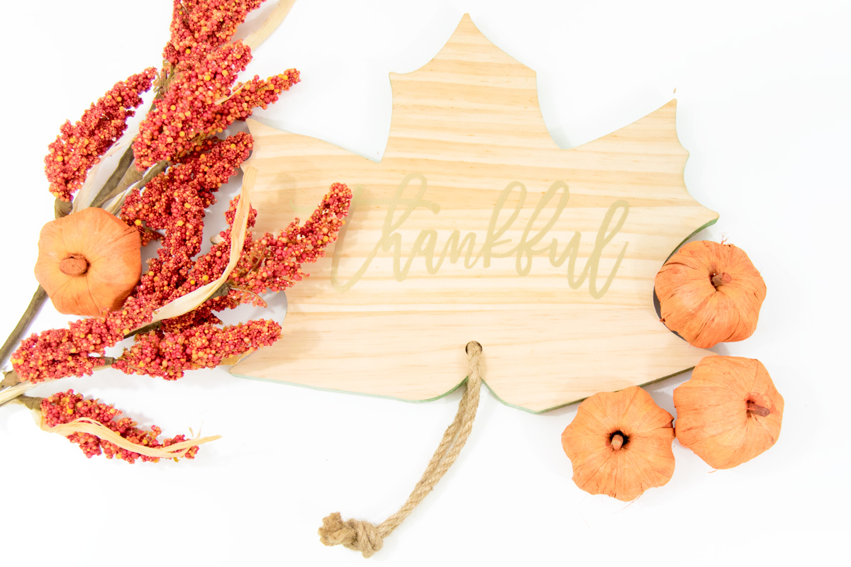 wooden leaf with gold thankful words on it