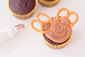 cupcake with brown frosting and pretzel antlers