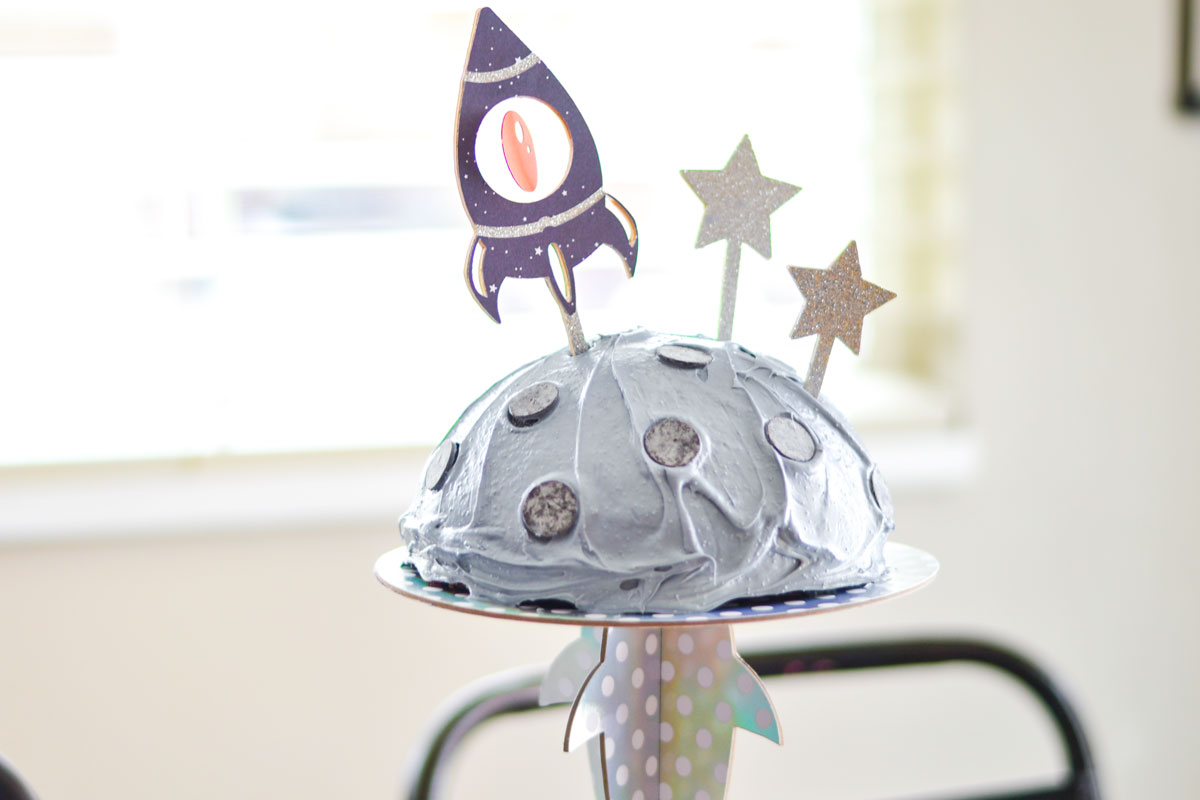 spaceship cricut cake topper on moon cake