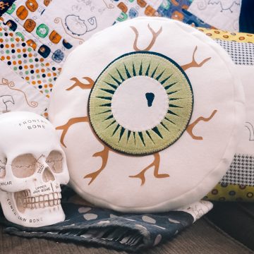 eyeball pillow on couch with skull