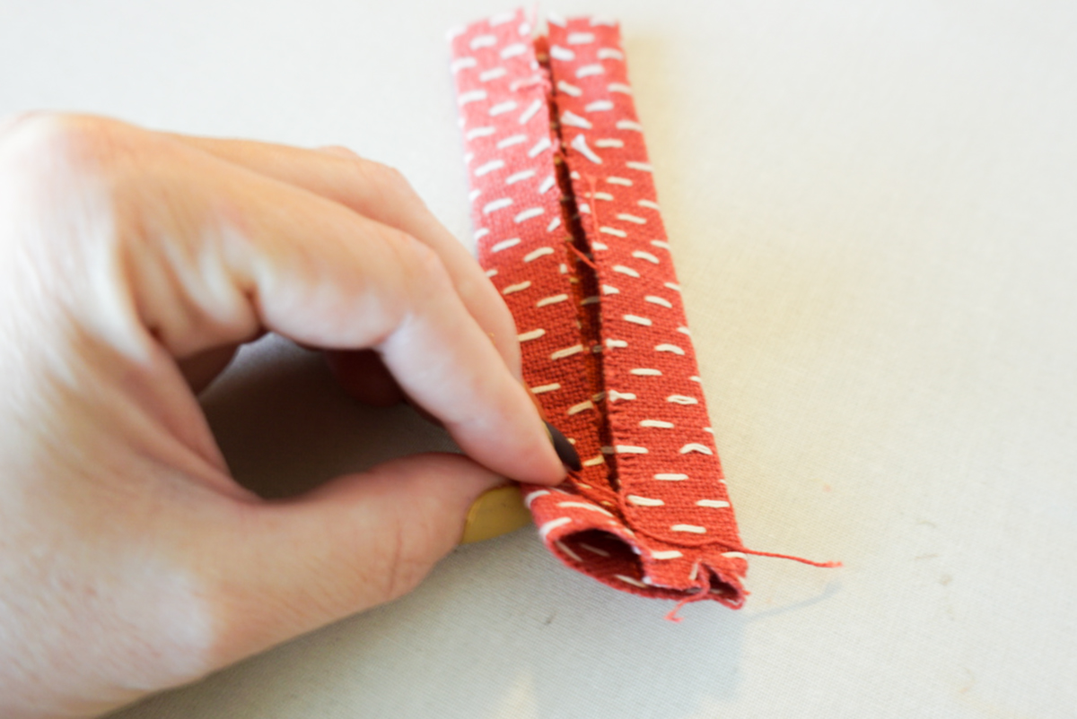 folding a stocking tab to sew